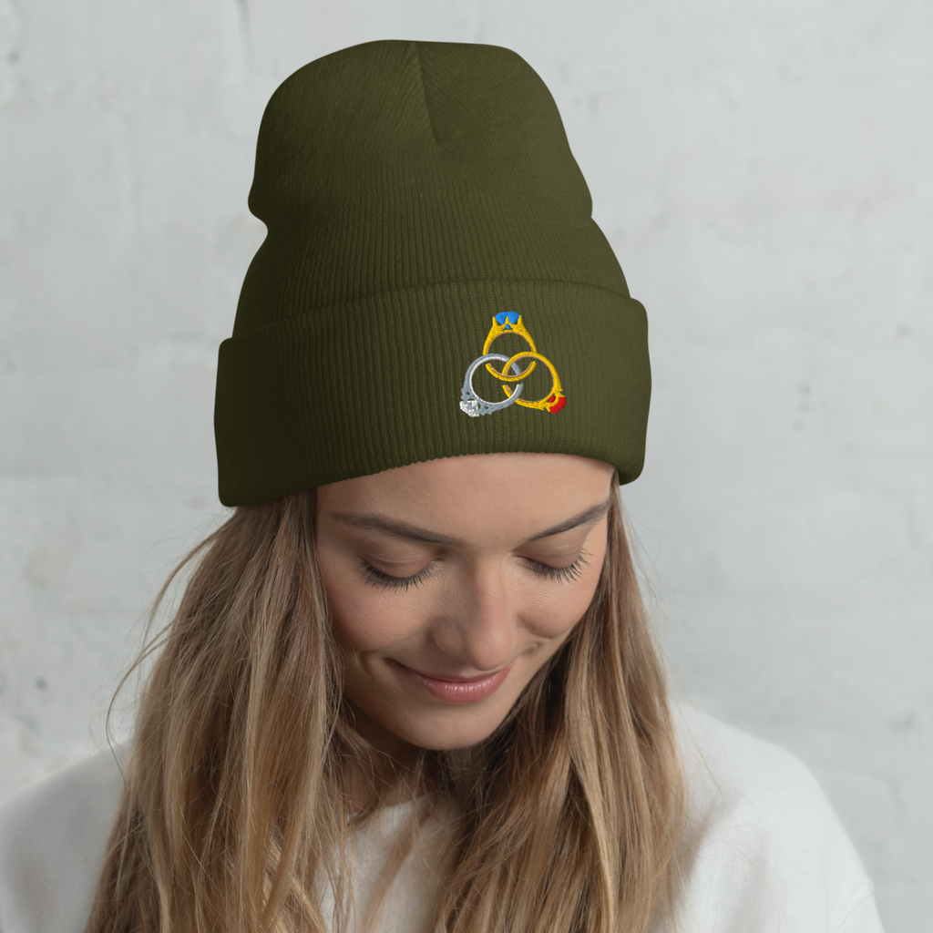 Model wearing an olive The Elven Rings cuffed beanie with three interlocking jeweled rings embroidered on the front.