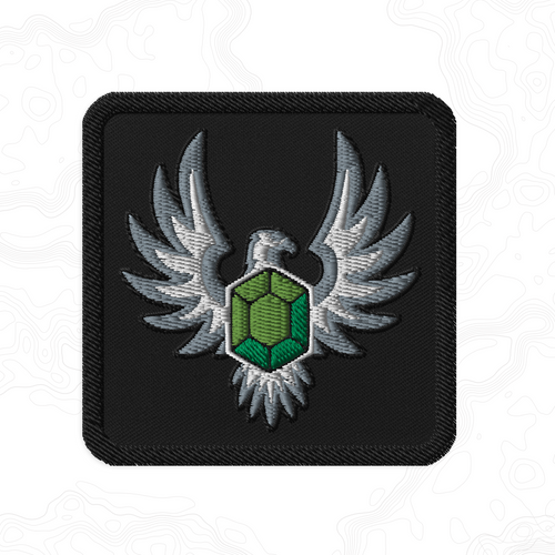 Elven Stone embroidered patch featuring a green gemstone framed by silver wings on a black background.