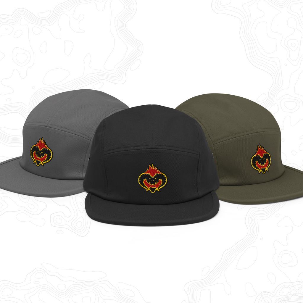 Fire Demon embroidered caps in dark gray, black, and olive, shown together.